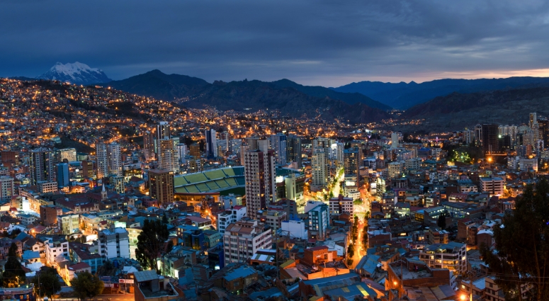 Bolivia skyline at dusk with lit buildings.