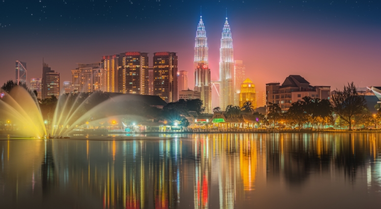 Malaysia skyline at night with lit buildings.